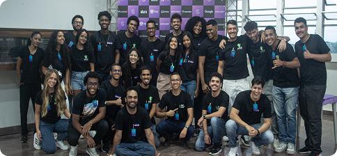 Grupo de estudantes sorrindo e pousando para foto durante o evento
